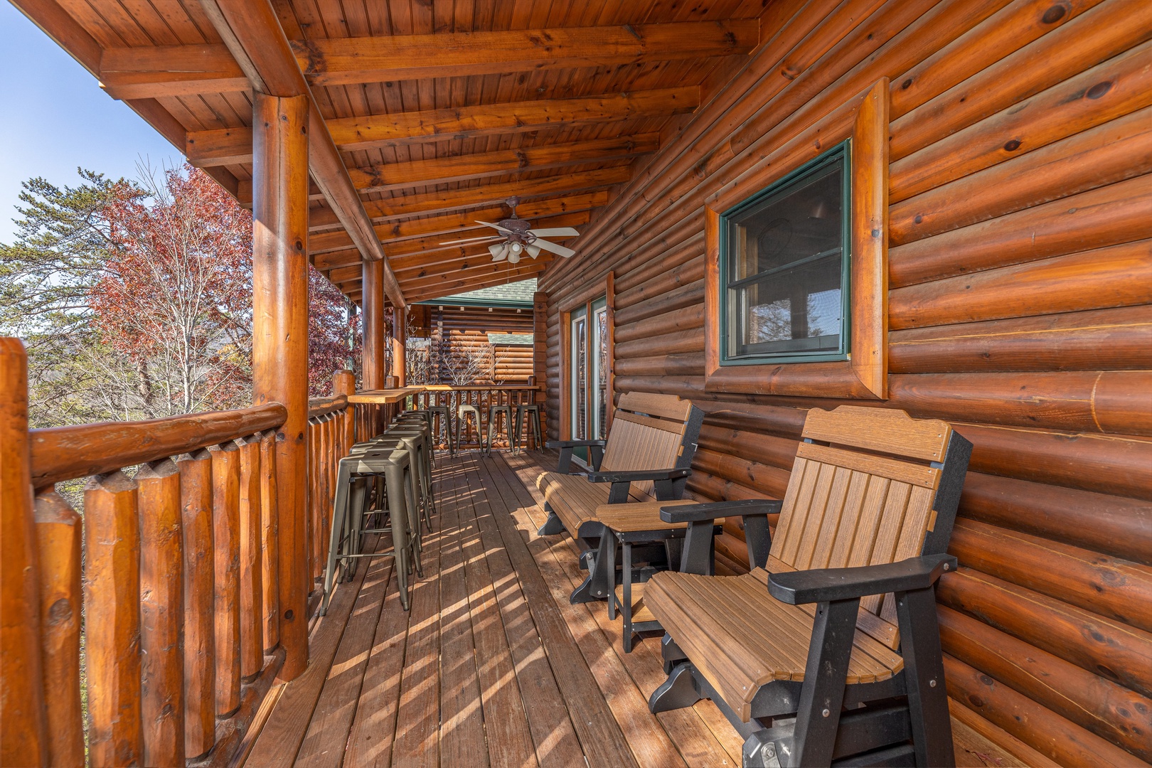 Bar stools & benches on a deck at Loving Every Minute, a 5 bedroom cabin rental located in Pigeon Forge
