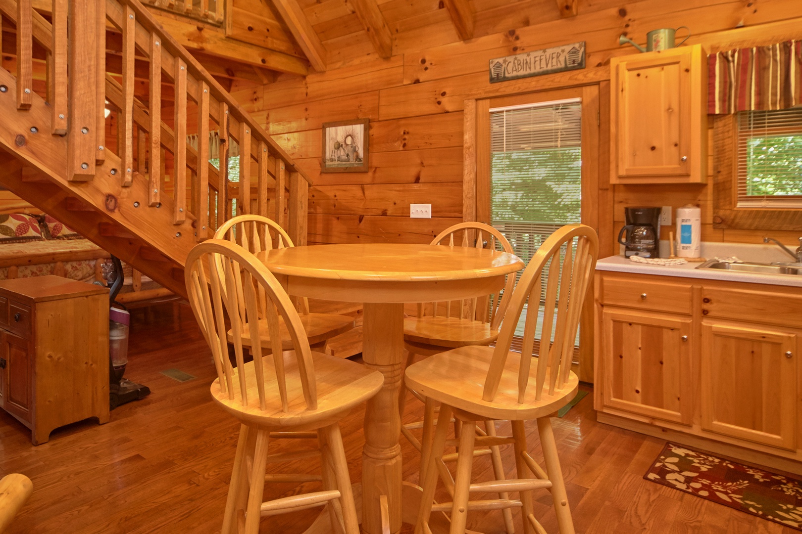 Dining table for four in the kitchen at Wild Crush, a 1 bedroom cabin rental located in Pigeon Forge