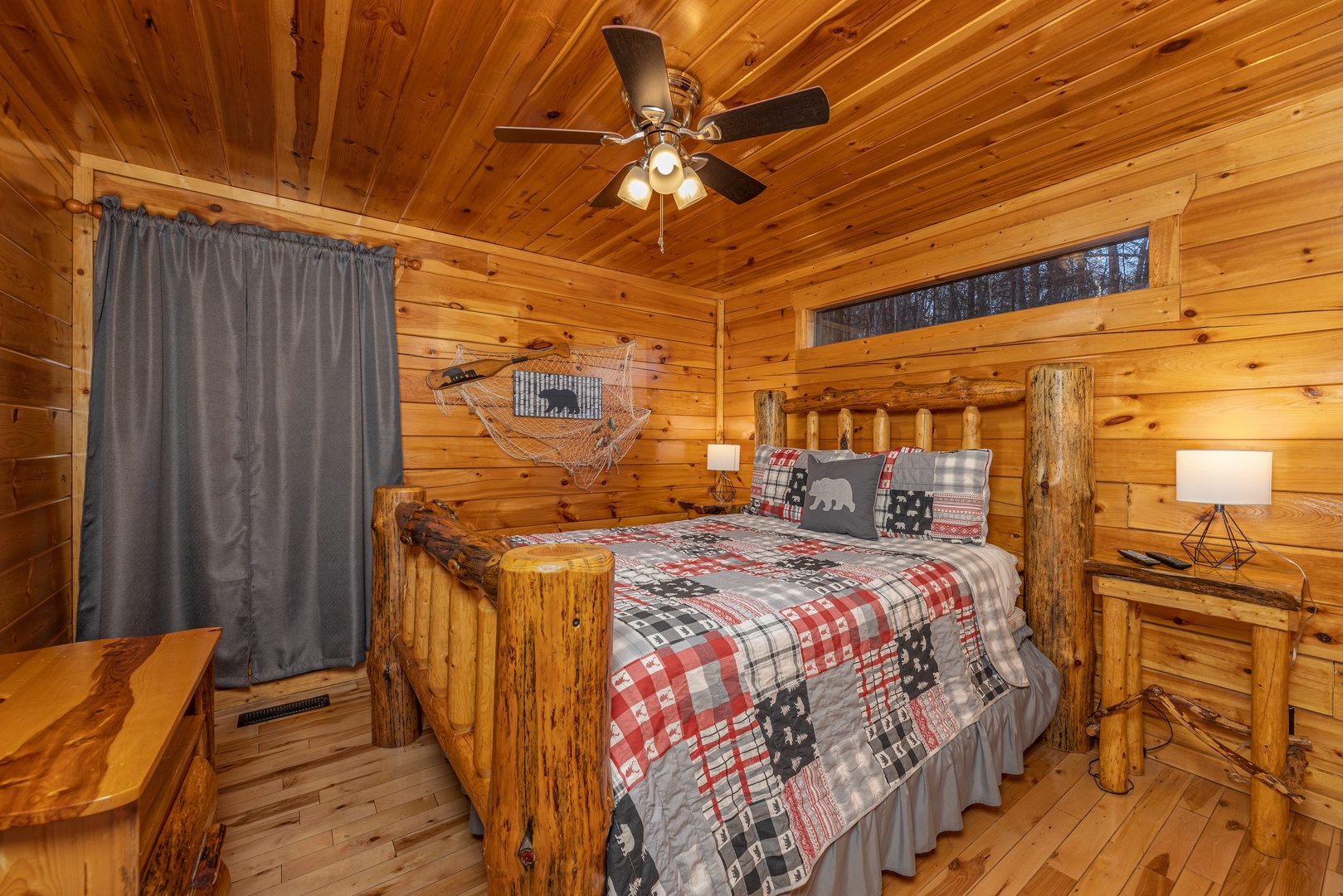 Bedroom with a log bed, night stands and lamps at A Bear on the Ridge, a 2 bedroom cabin rental located in Pigeon Forge