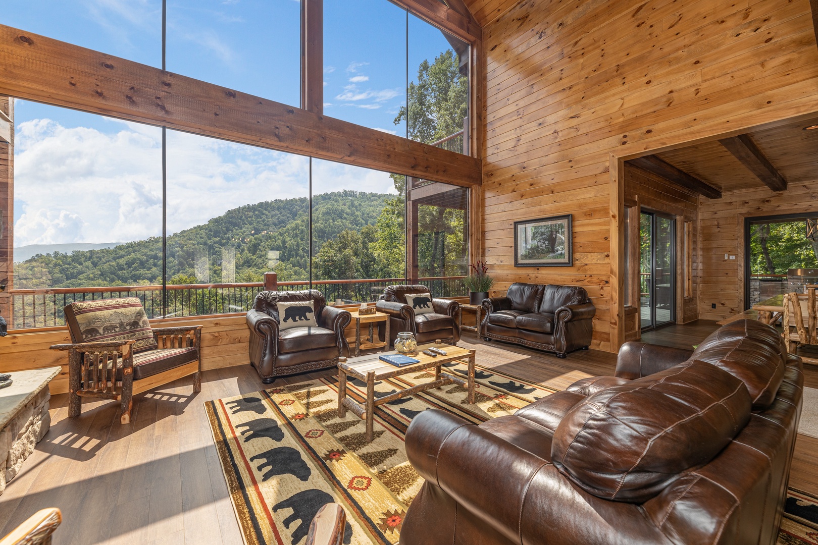 Living room with lots of seating and large windows at Black Bears & Biscuits Lodge, a 6 bedroom cabin rental located in Pigeon Forge