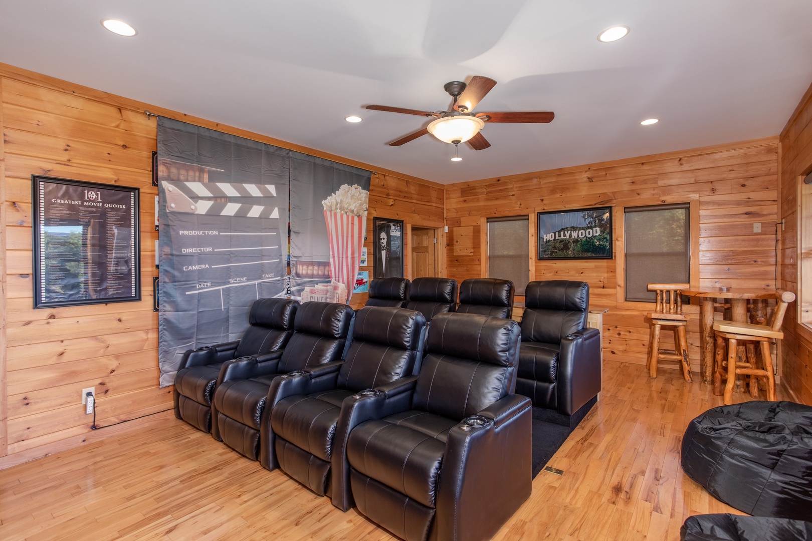 Eight reclining seats in the theater room at Great View Lodge, a 5-bedroom cabin rental located in Pigeon Forge