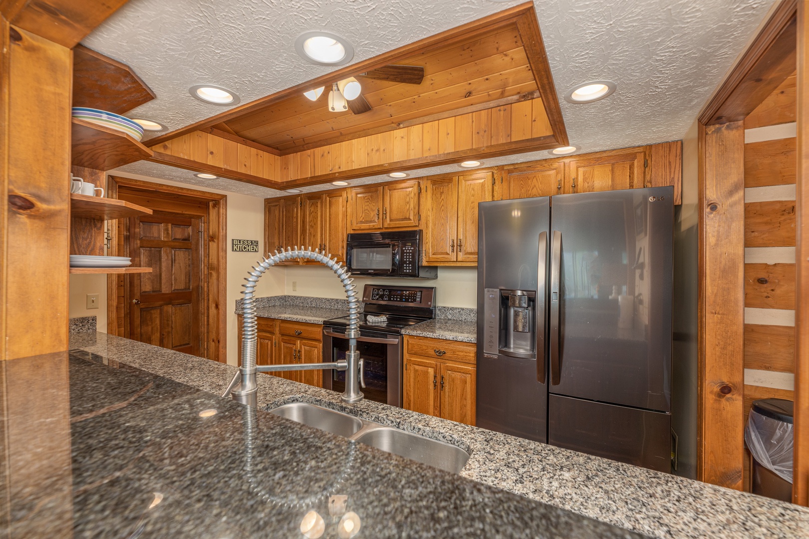 Kitchen with black appliances at Cubs' Crib, a 3 bedroom cabin rental located in Gatlinburg