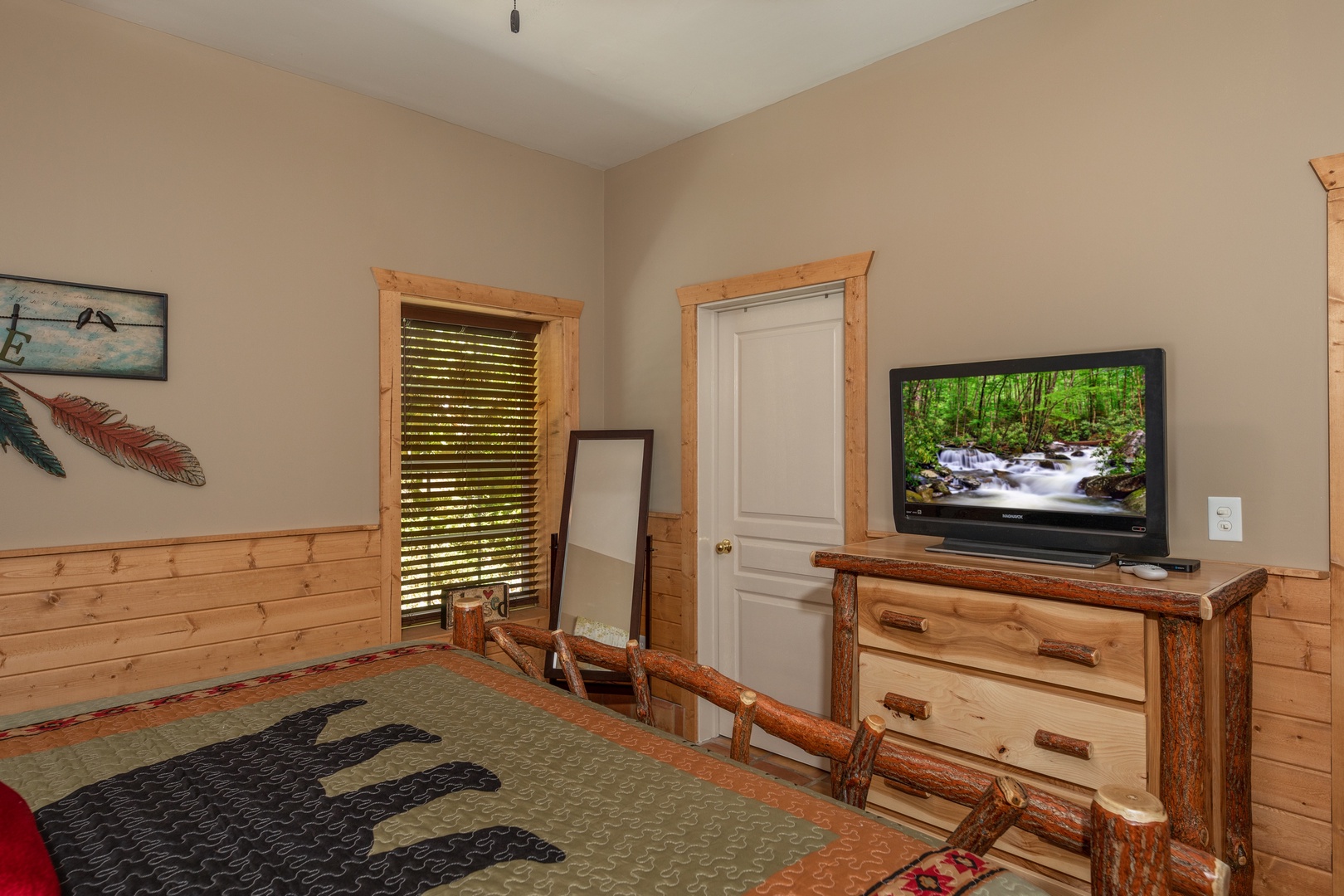 Dresser, mirror, and tv in a bedroom at Hawk's Heart Lodge, a 3 bedroom cabin rental located in Pigeon Forge