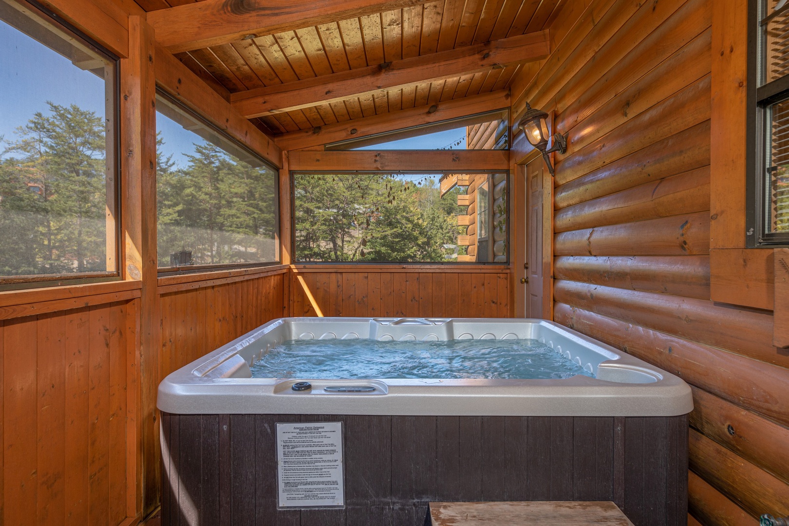 Hot tub on a covered deck at Bearadise 4 Us, a 3 bedroom cabin rental located in Pigeon Forge