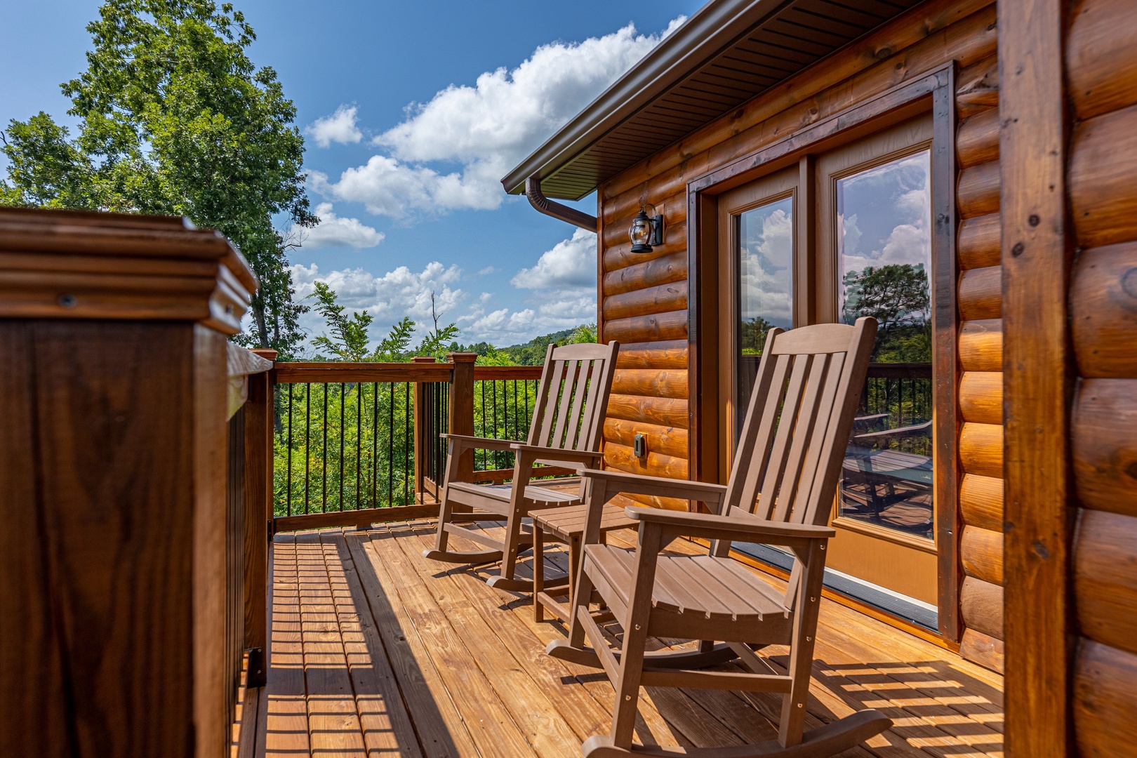 Rocking chairs on the deck at Twin Peaks, a 5 bedroom cabin rental located in Gatlinburg