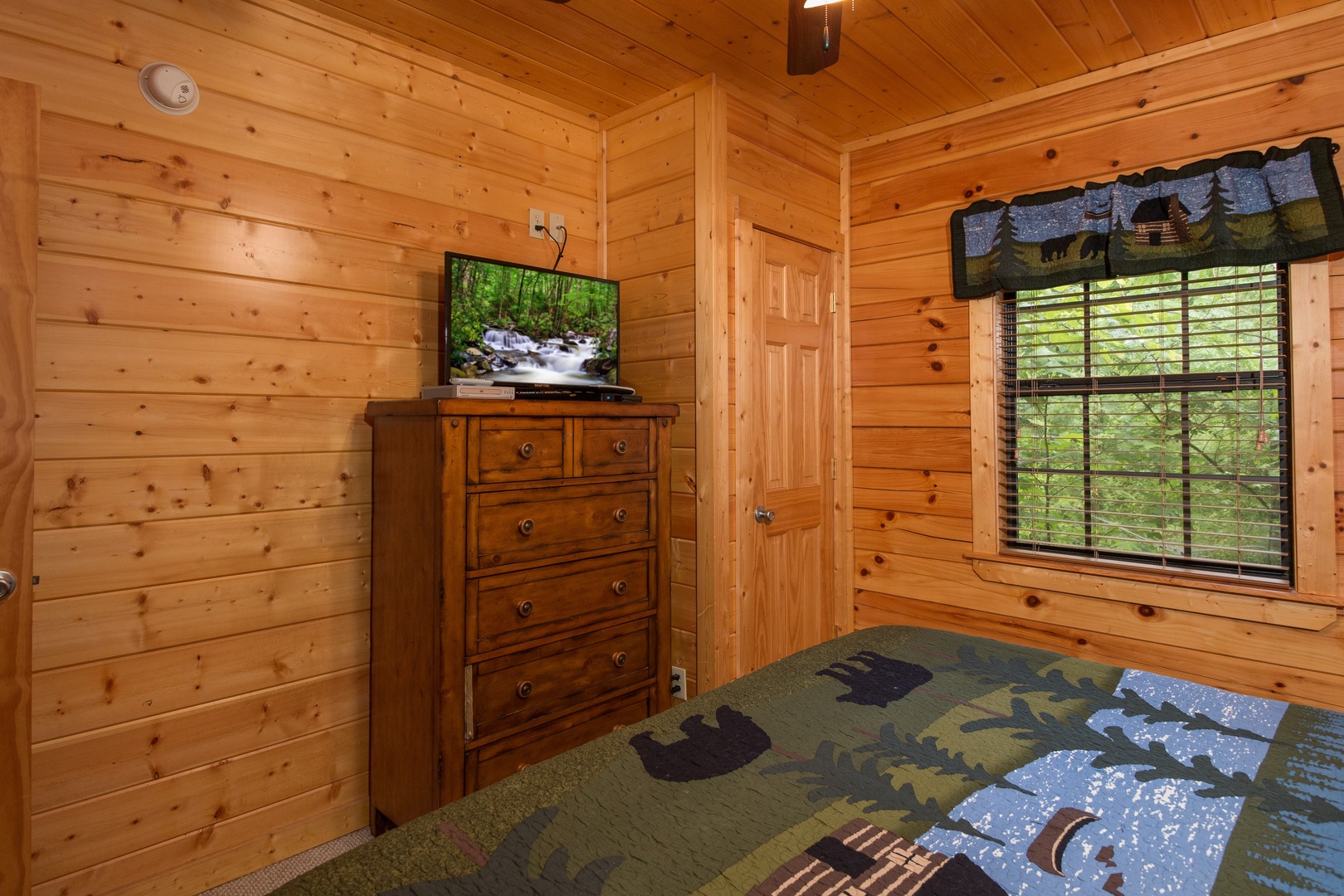 Bedroom flat screen on the dresser at Family Ties Lodge, a 4 bedroom cabin rental located in pigeon forge