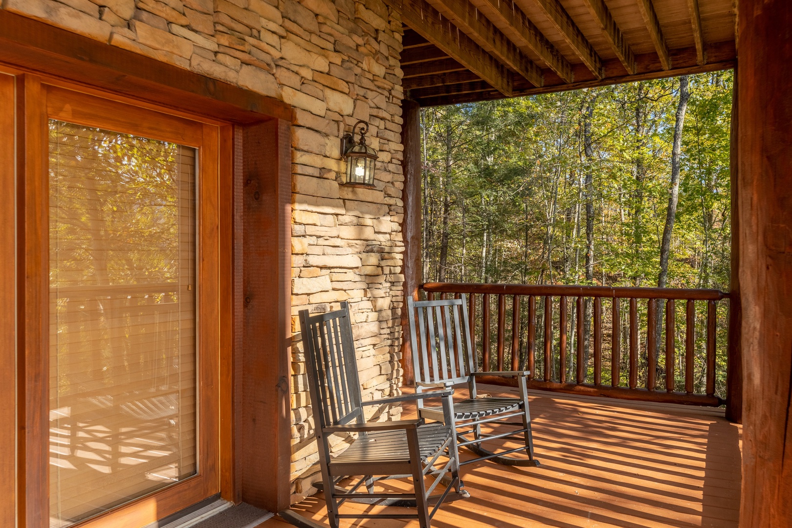 Rocking chairs on a deck at Grizzly's Den, a 5 bedroom cabin rental located in Gatlinburg