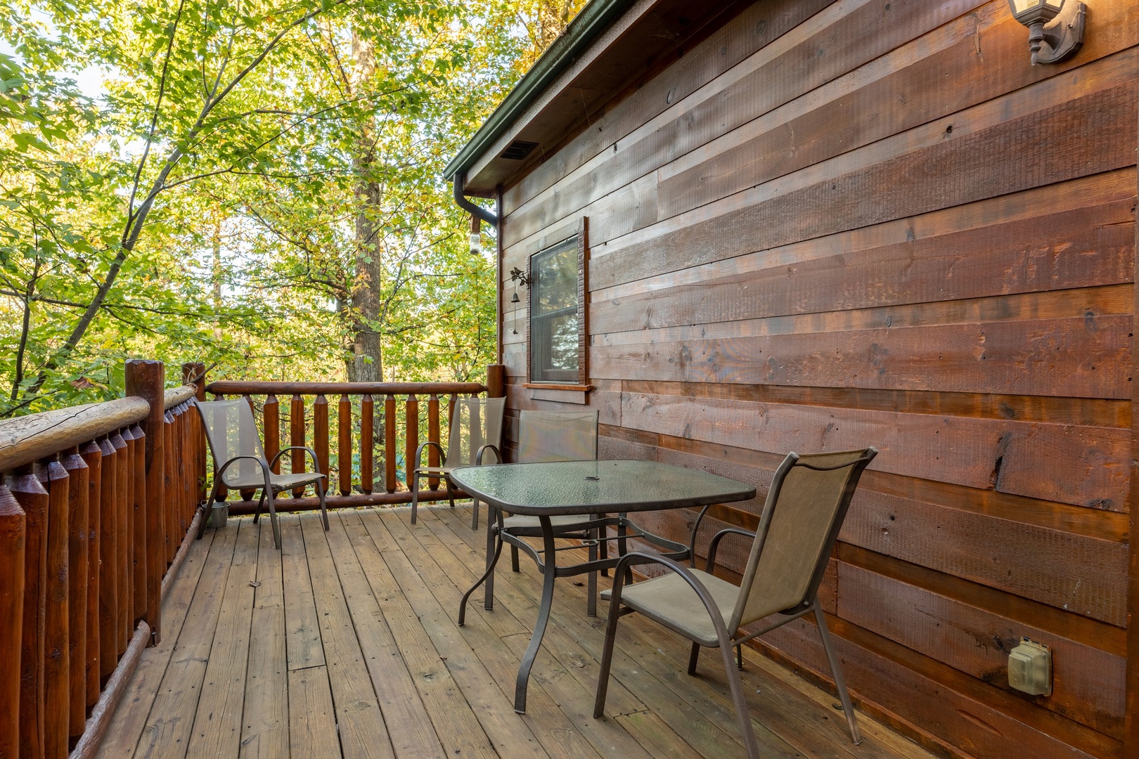Outdoor dining on the deck at Firefly Ridge, a 2 bedroom cabin rental located in Pigeon Forge