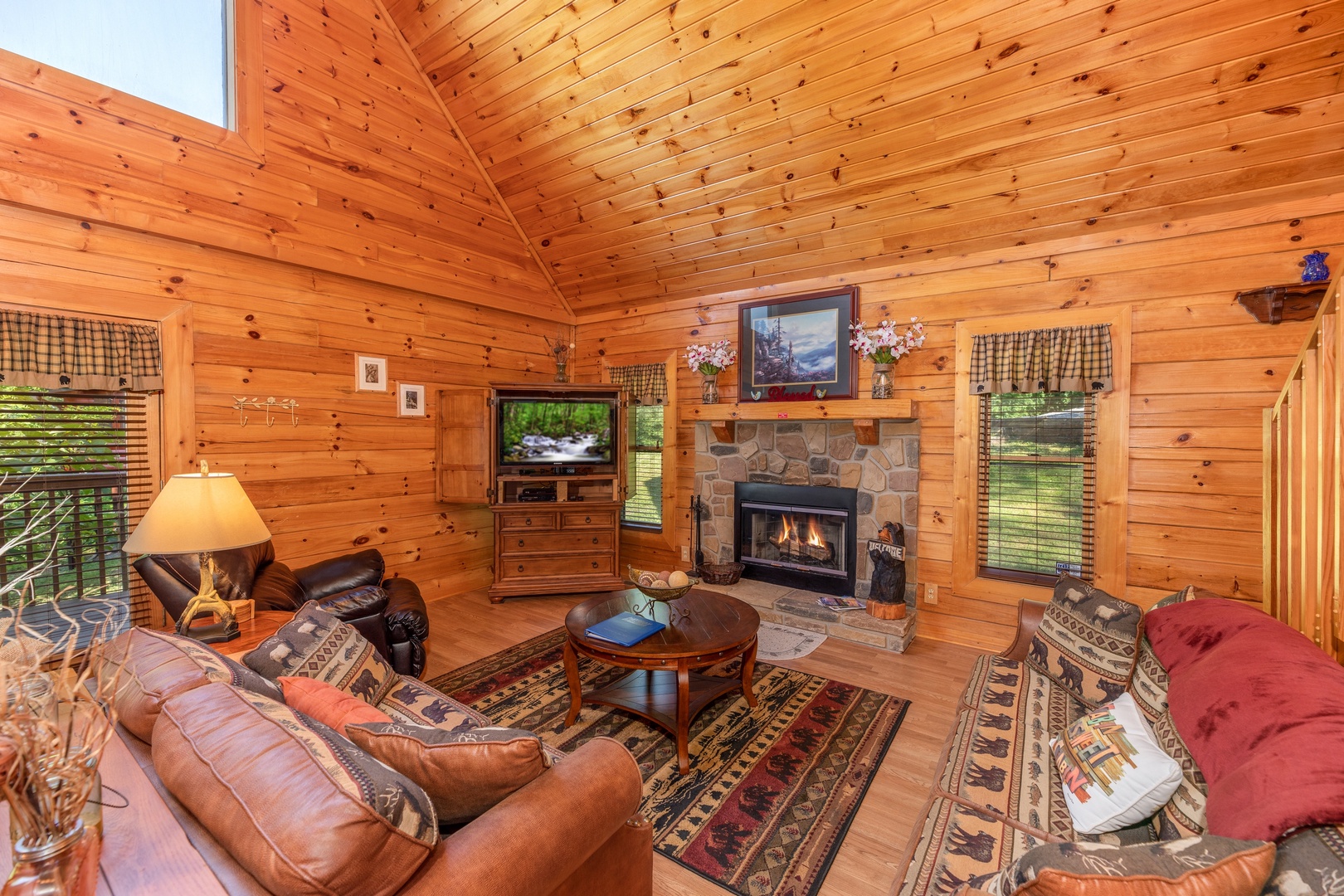 Living room with TV and fireplace at Grand View, a 3 bedroom cabin rental located in Sevierville