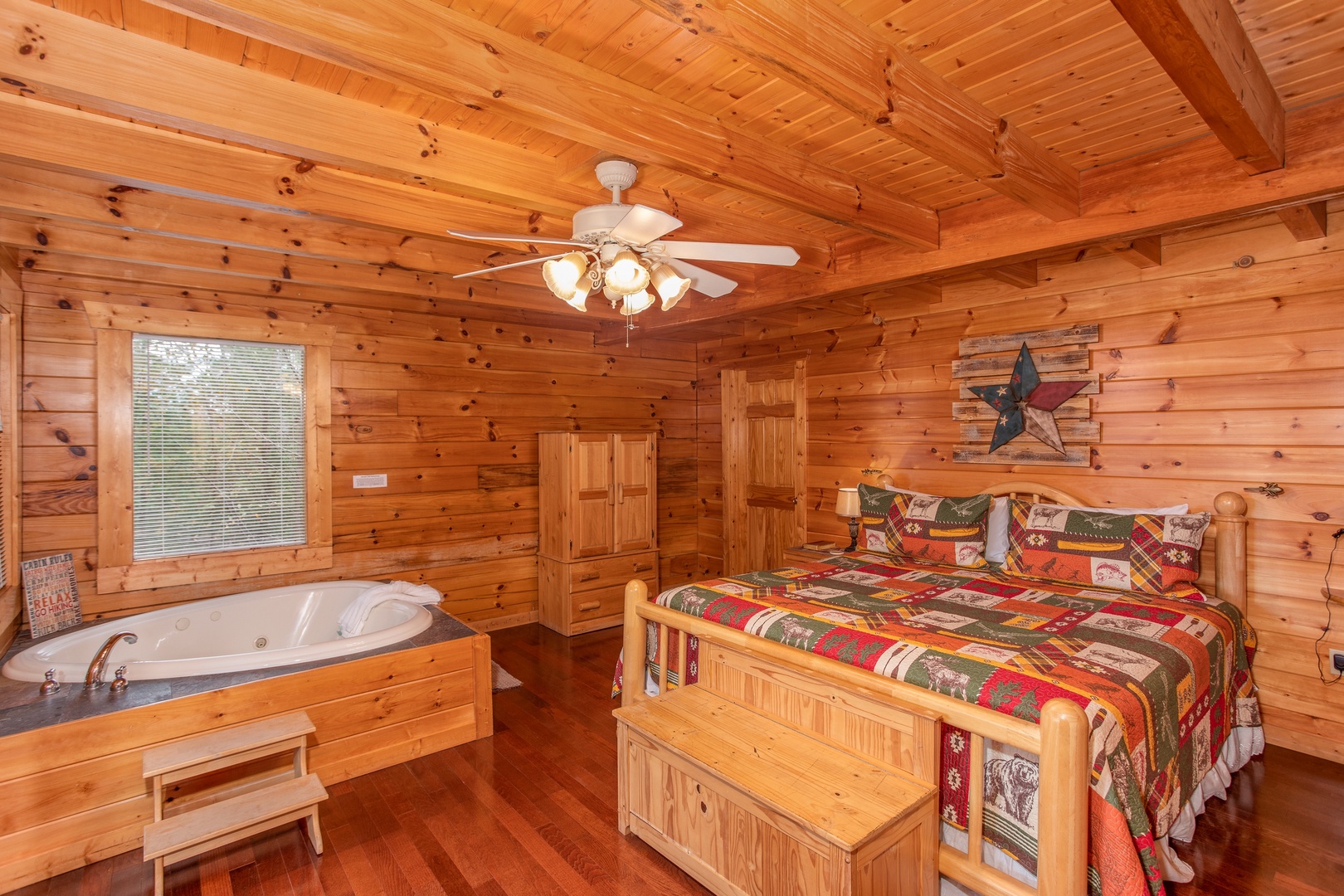 First king-sized bedroom with heart-shaped jacuzzi tub at Enchanted Evening, a 1-bedroom cabin rental located in Pigeon Forge