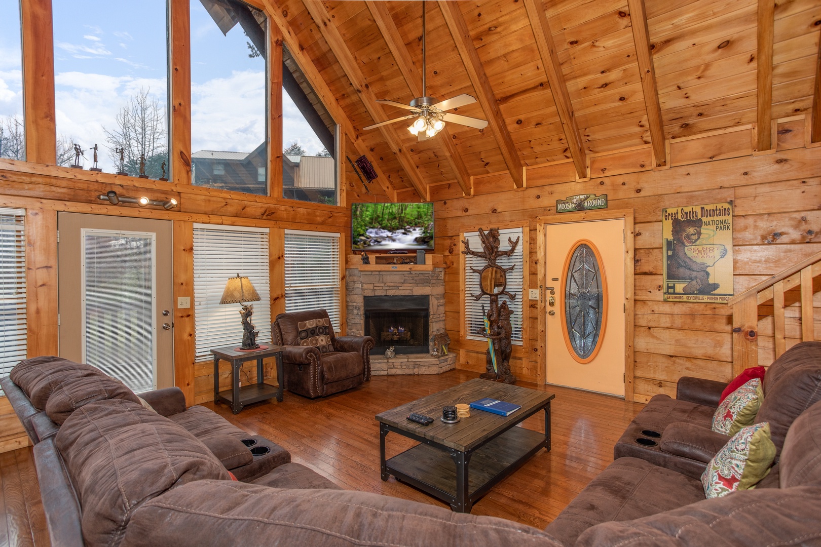 Living room with fireplace, TV, and vaulted ceiling at Mountain Music, a 5 bedroom cabin rental located in Pigeon Forge