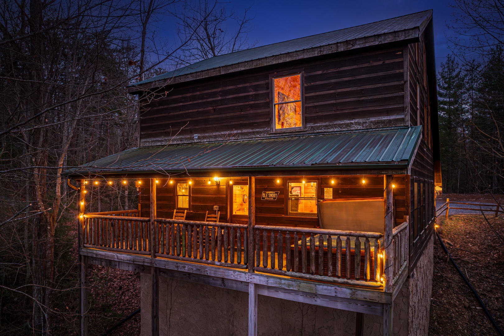Covered Deck at night at Moonshine Memories, a 2 bedroom cabin rental located in Gatlinburg