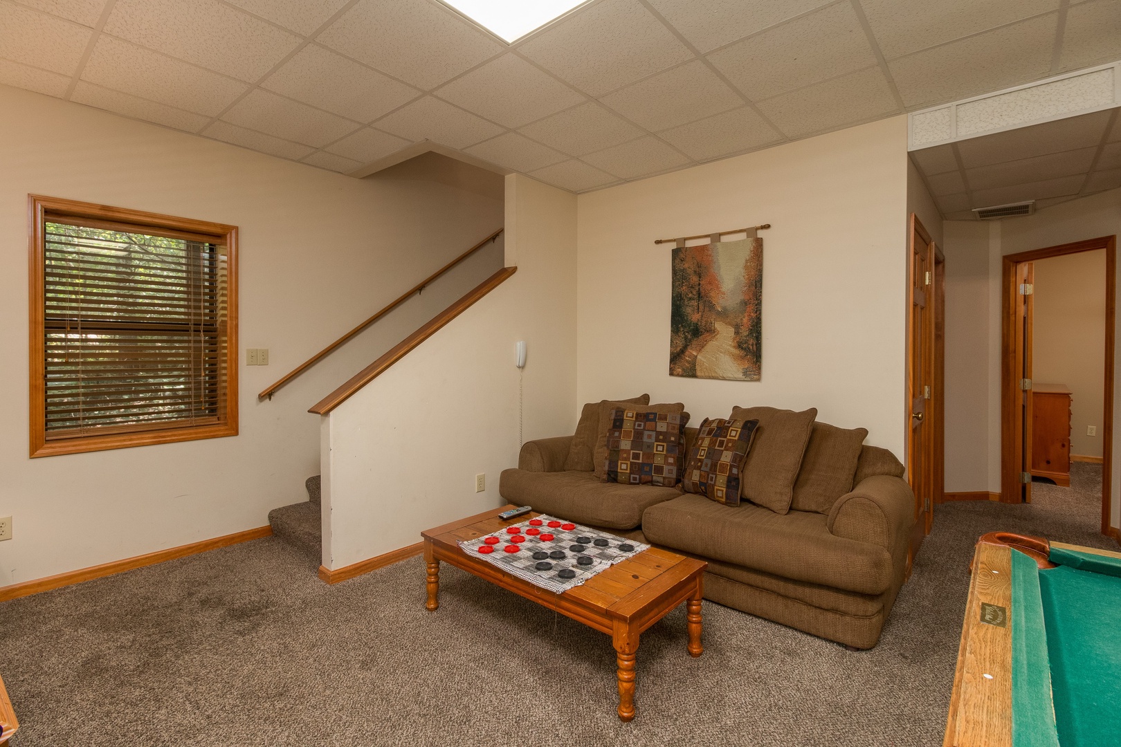 Lower living room at Stones Throw, a 4 bedroom cabin rental located in Pigeon Forge
