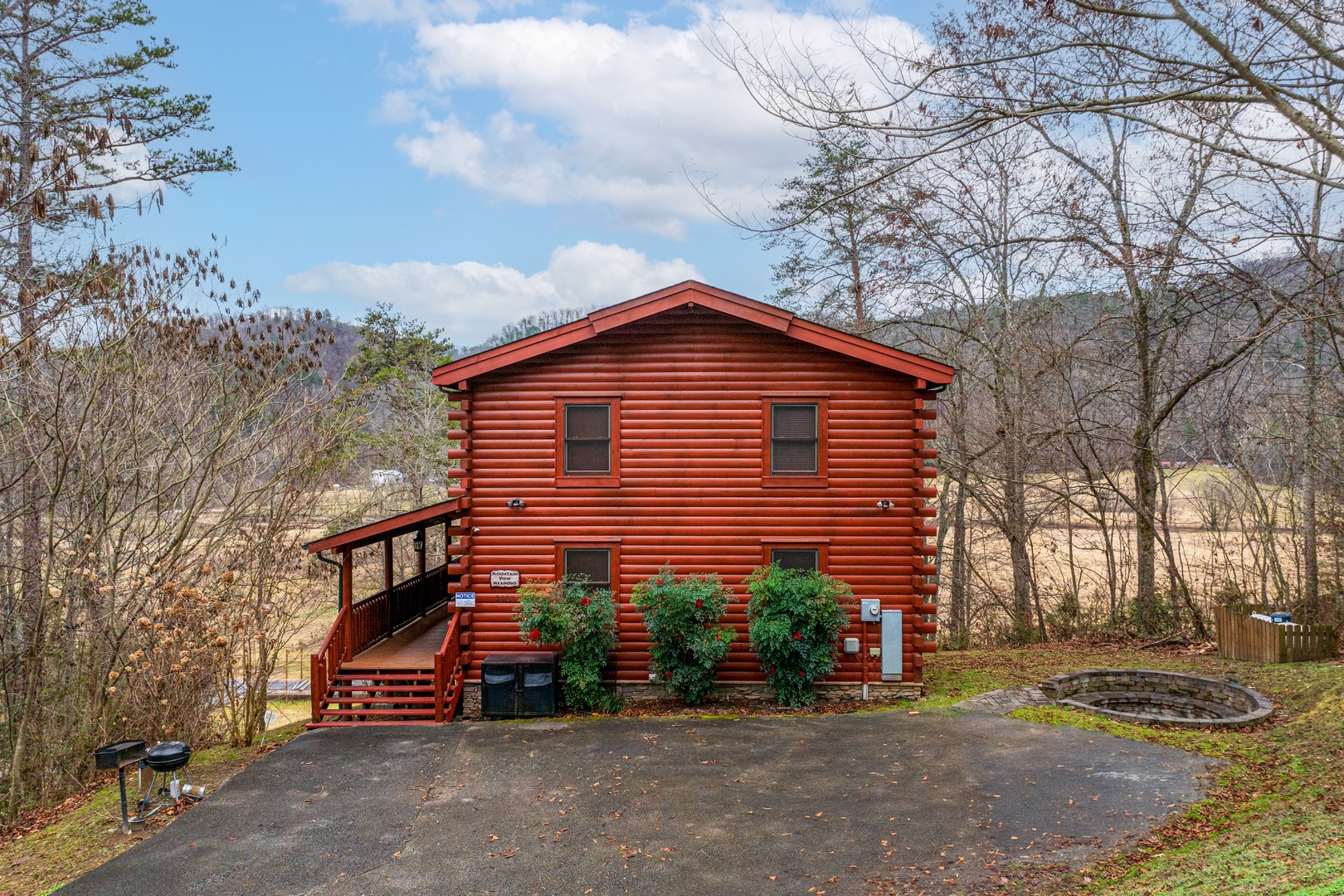 Cabin and fire pit with the meadow nearby at Mountain View Meadows, a 3 bedroom cabin rental located in Pigeon Forge