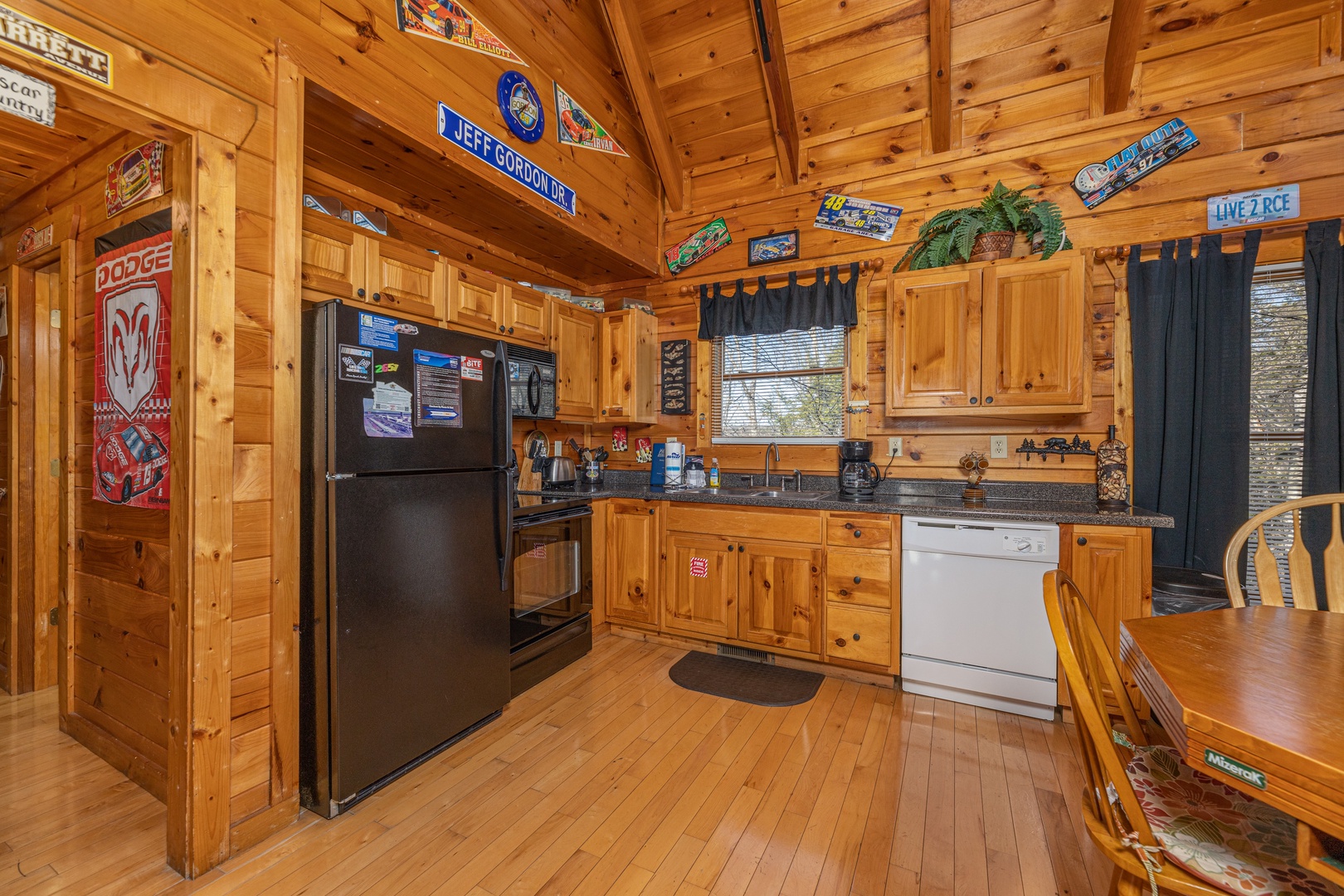 Kitchen with black and white appliances at Nascar Nation, a 2 bedroom cabin rental located in Pigeon Forge