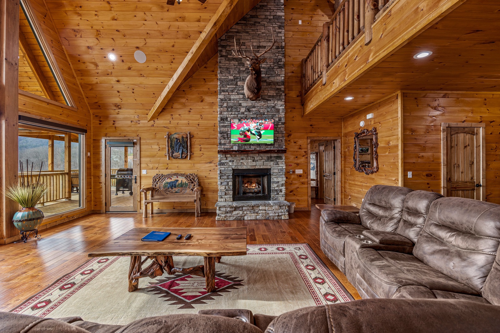 Living room fireplace and tv at Four Seasons Grand, a 5 bedroom cabin rental located in Pigeon Forge