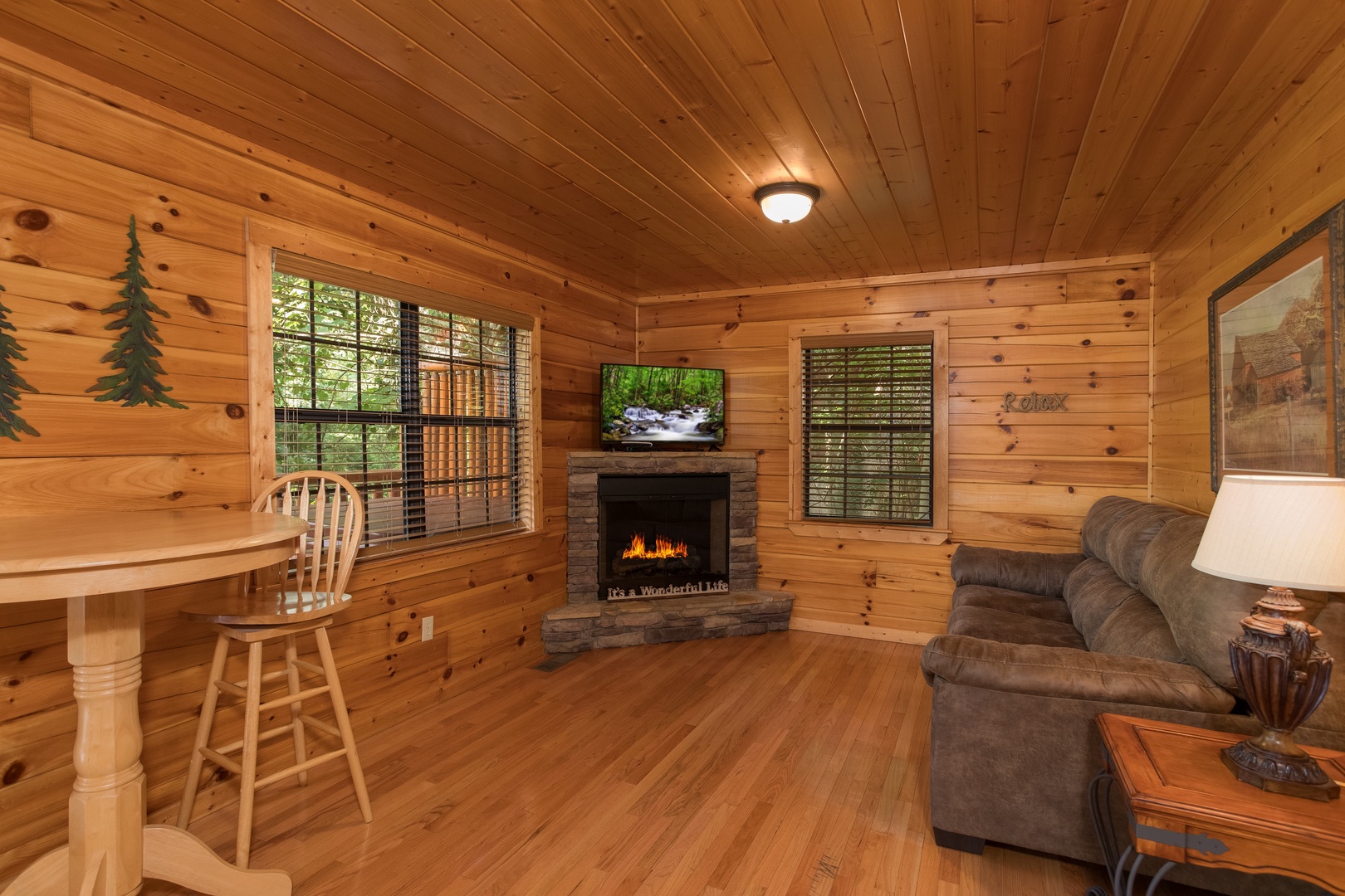 Fireplace and TV in the lower living room at Kick Back & Relax! A 4 bedroom cabin rental located in Pigeon Forge