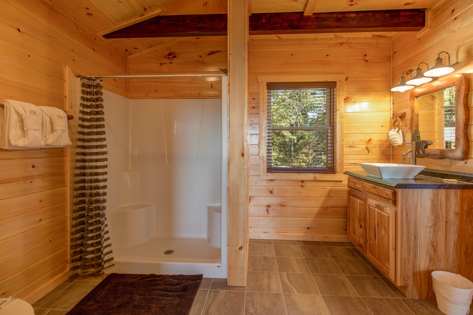 Bathroom with a shower stall at Canyon Camp Falls, a 2 bedroom cabin rental located in Pigeon Forge
