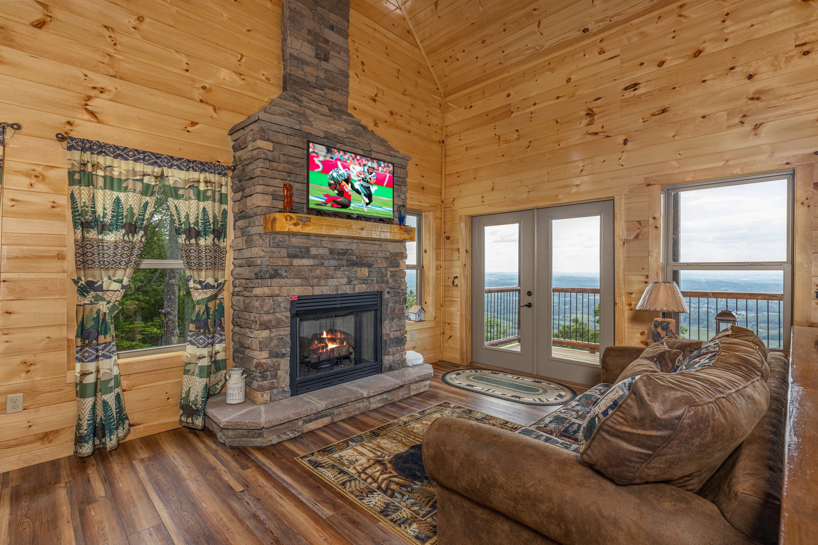 Living room with fireplace, TV, and mountain views at 4 States View, a 2 bedroom cabin rental located in Pigeon Forge