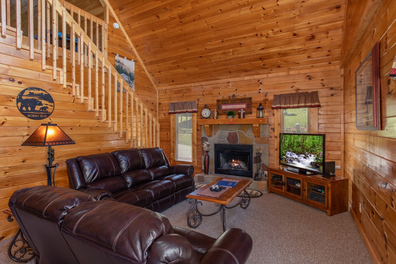 Living room with a fireplace and TV at Momma Bear, a 2 bedroom cabin rental located in Pigeon Forge