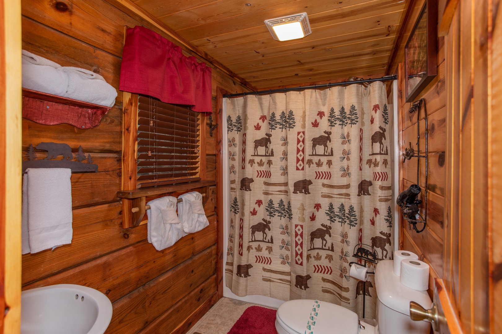 Bathroom with a tub and shower at Moonshiner's Ridge, a 1-bedroom cabin rental located in Pigeon Forge