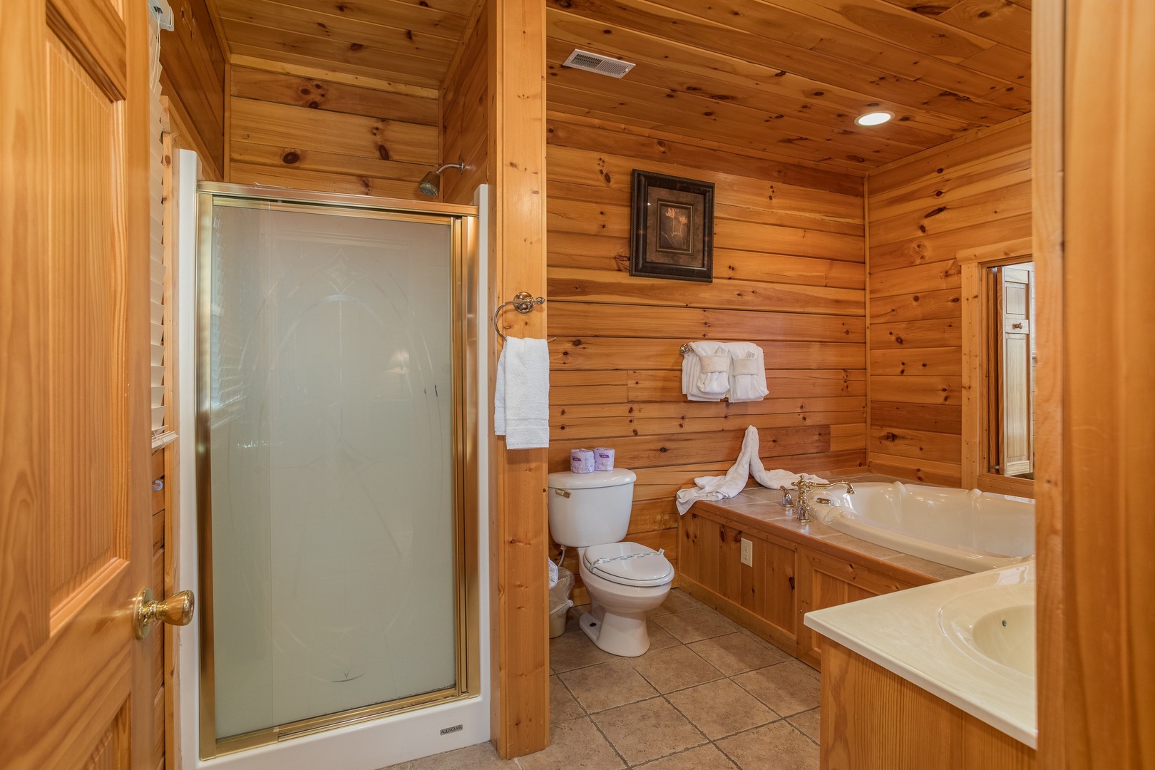 Bathroom with a jacuzzi tub and separate shower at Howlin' in the Smokies, a 2 bedroom cabin rental located in Pigeon Forge