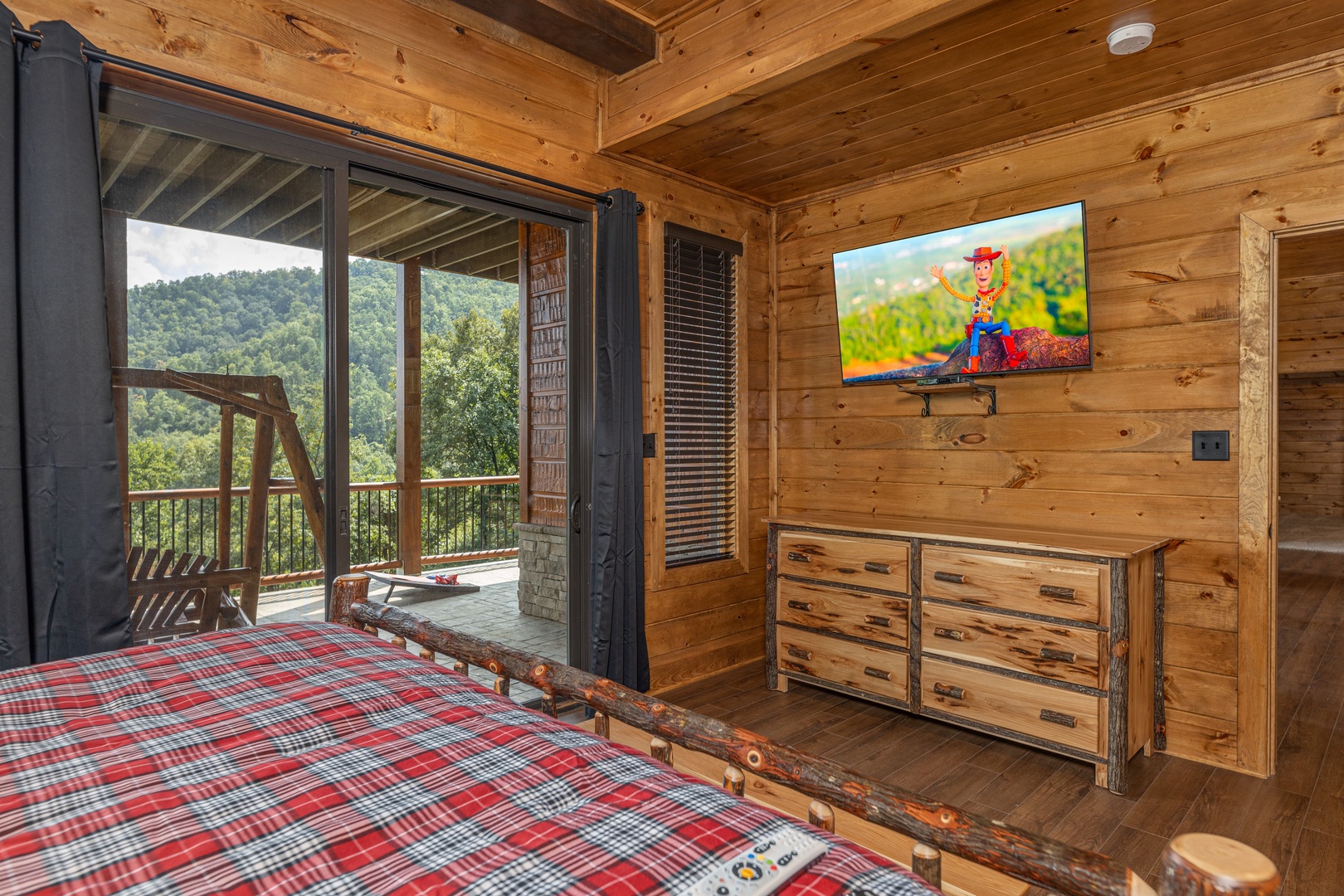 Dresser, TV, and deck access at Black Bears & Biscuits Lodge, a 6 bedroom cabin rental located in Pigeon Forge