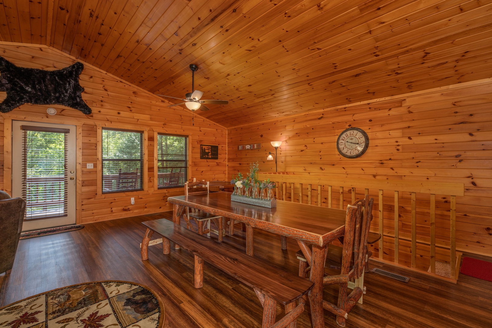 Dining table with chairs and bench seating at Hawk's Heart Lodge, a 3 bedroom cabin rental located in Pigeon Forge