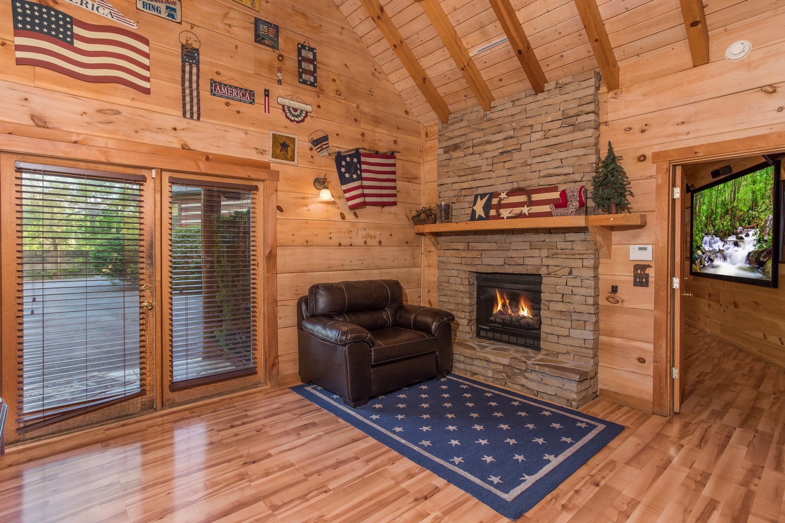 Fireplace and chair in the game room at Patriot Pointe, a 5 bedroom cabin rental located in Pigeon Forge