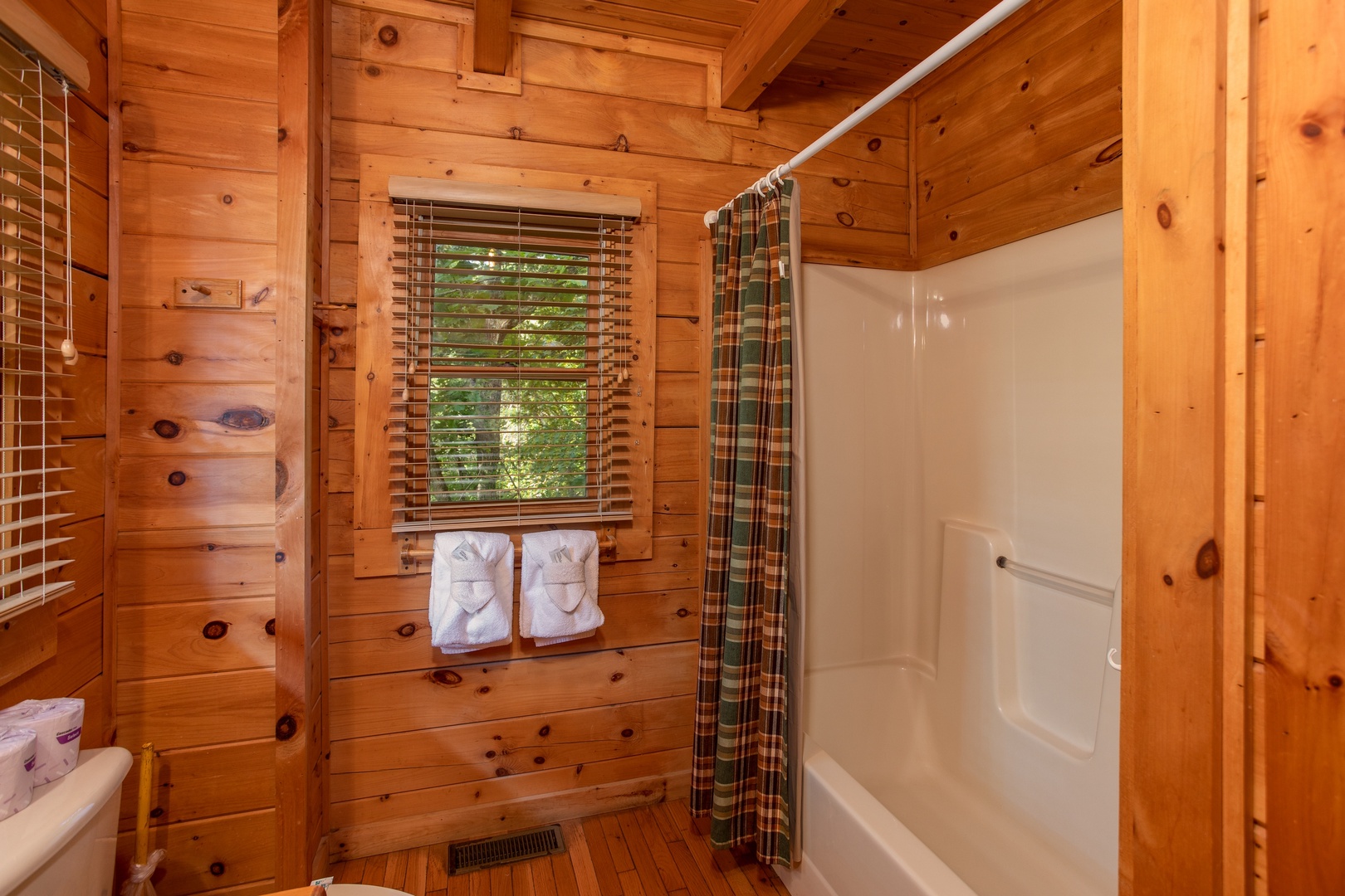 Bathroom with a tub and shower at Dreams Do Come True, a 1-bedroom cabin rental located in Pigeon Forge