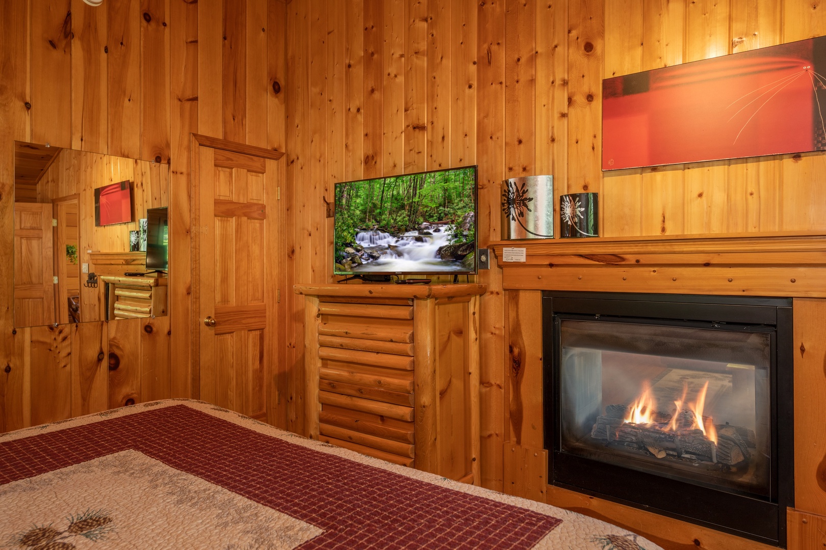 TV and fireplace in a bedroom at Hello Dolly, a 1 bedroom cabin rental located in Pigeon Forge
