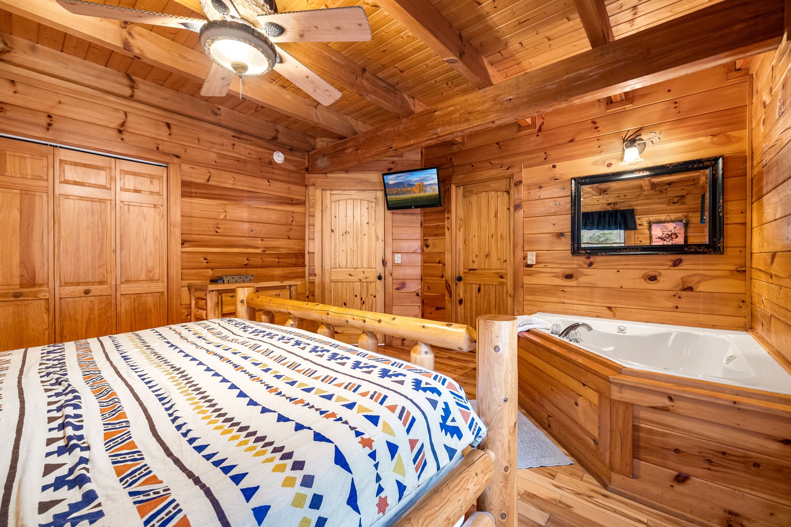 Bedroom with jacuzzi and tv at Alpine Sondance, a 2 bedroom cabin rental located in Pigeon Forge
