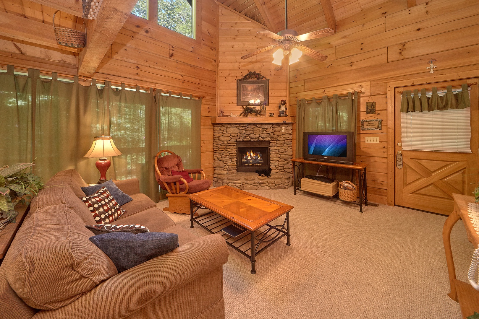 Living room with fireplace and television at A Place to Remember, a 2 bedroom cabin rental located in Gatlinburg