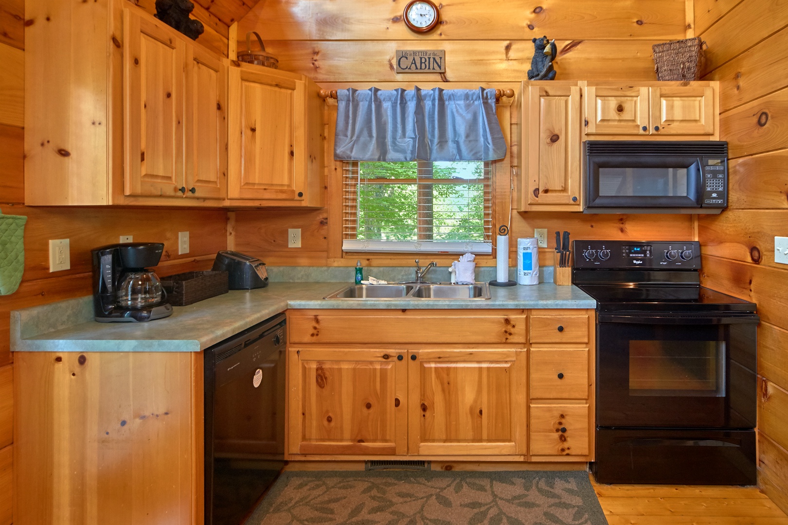 Kitchen with black appliances at Love Struck, a 1 bedroom cabin rental located in Pigeon Forge