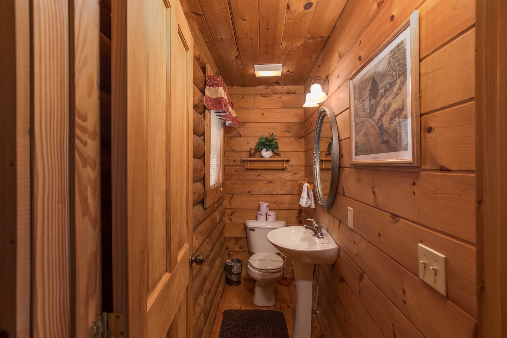 Half bath at Hanky Panky, a 1-bedroom cabin rental located in Pigeon Forge