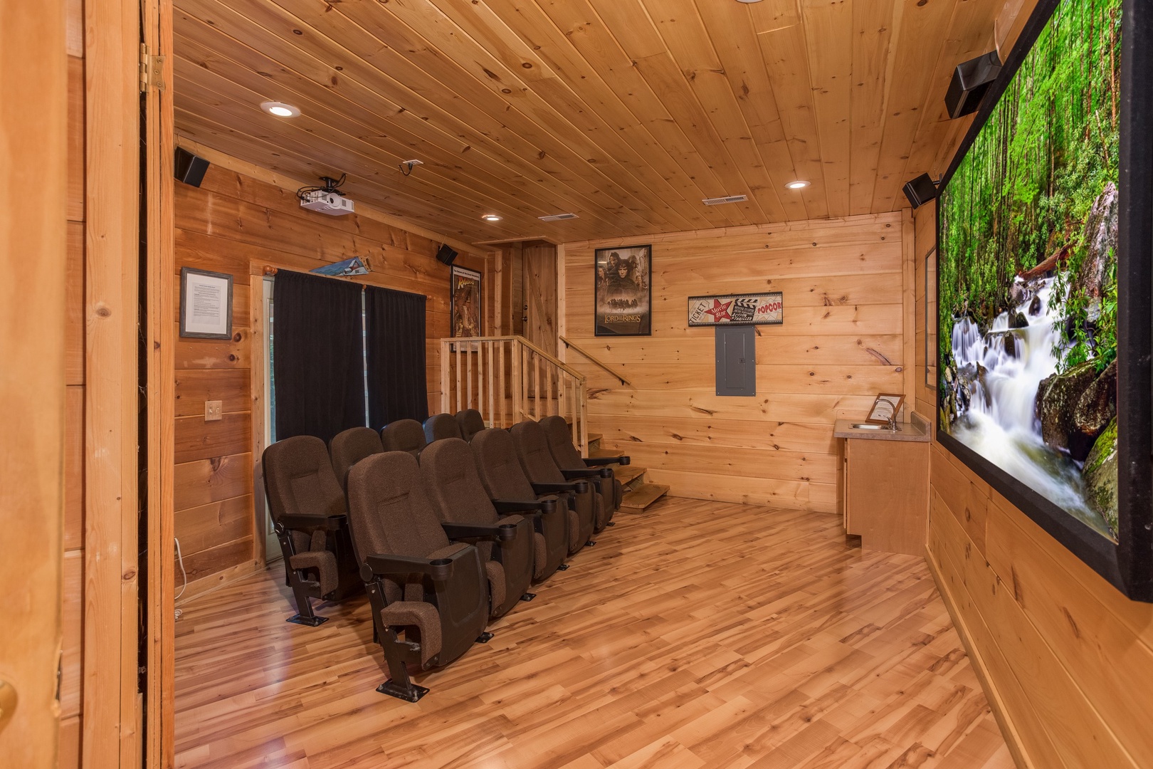 Seating in the theater room at Patriot Pointe, a 5 bedroom cabin rental located in Pigeon Forge