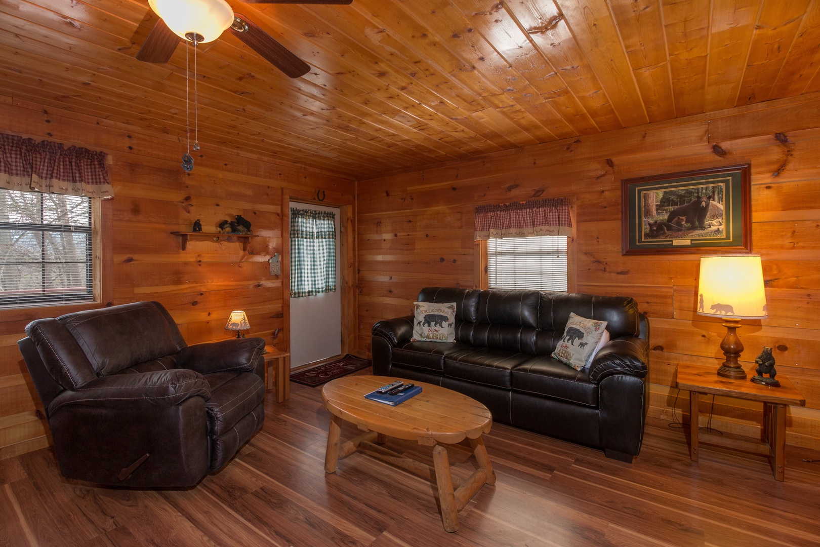 Living room with sofa and recliner at Beary Good Time, a 1-bedroom cabin rental located in Pigeon Forge