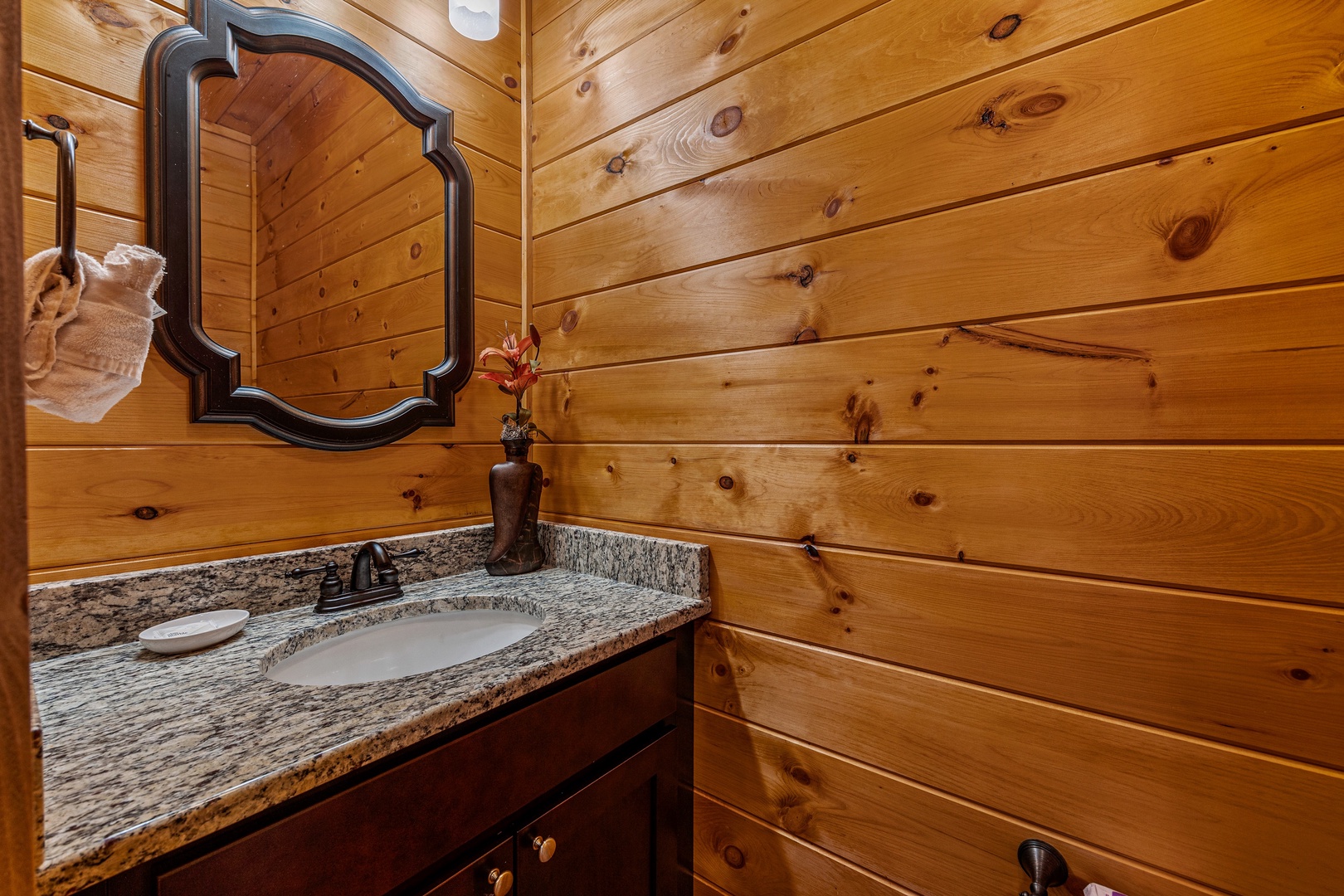 Bathroom sink and mirror at Four Seasons Grand, a 5 bedroom cabin rental located in Pigeon Forge