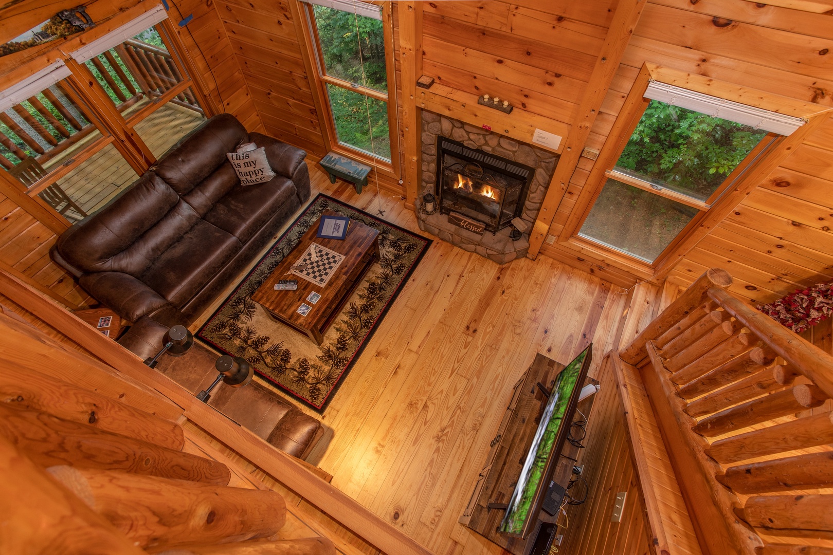 Looking down into the living room from the upper floor at Lazy Mountain Retreat, a 1 bedroom cabin rental located in Gatlinburg