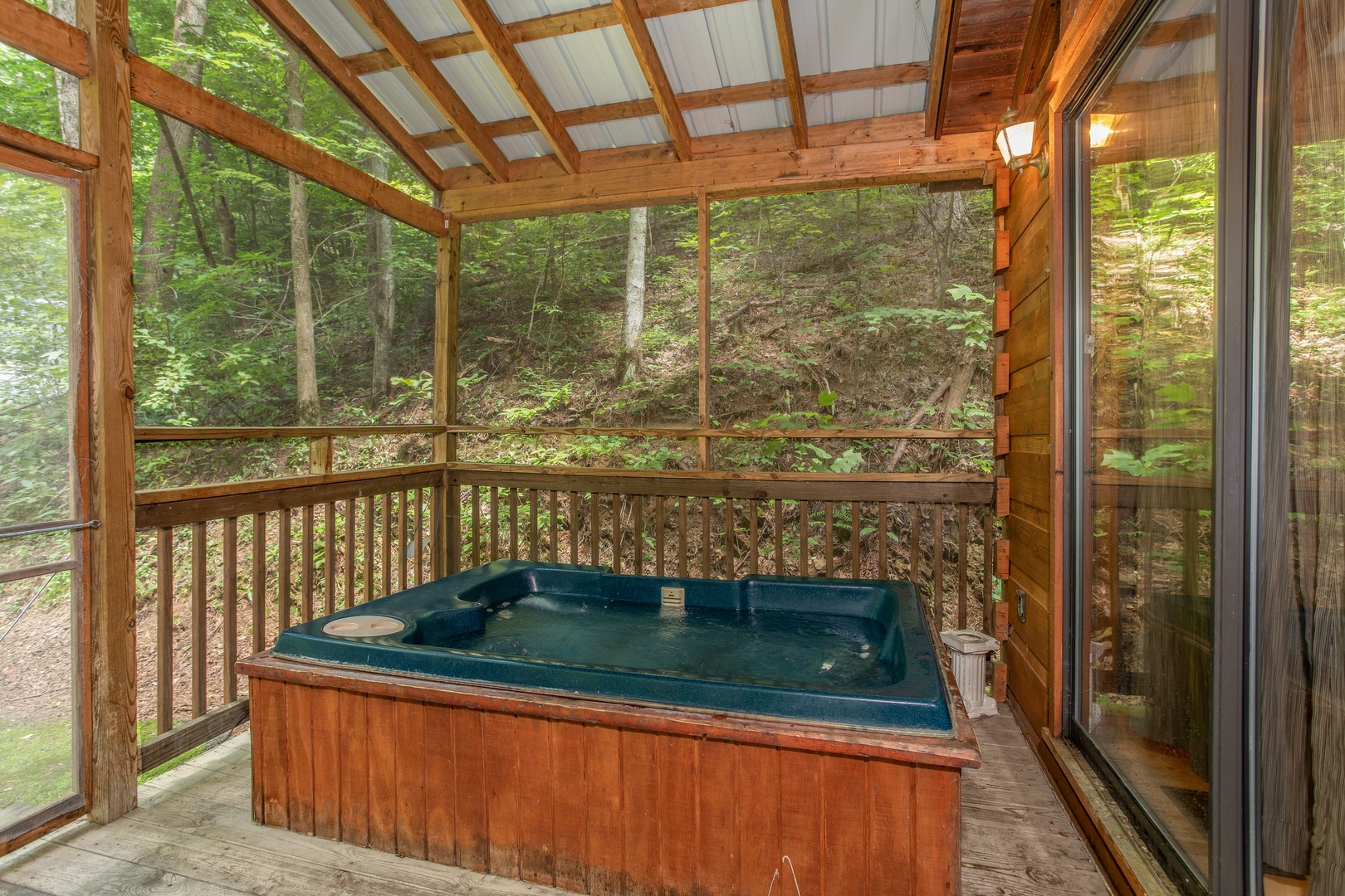 hot tub on a screened in porch at angel's dream a 1 bedroom cabin rental located in gatlinburg