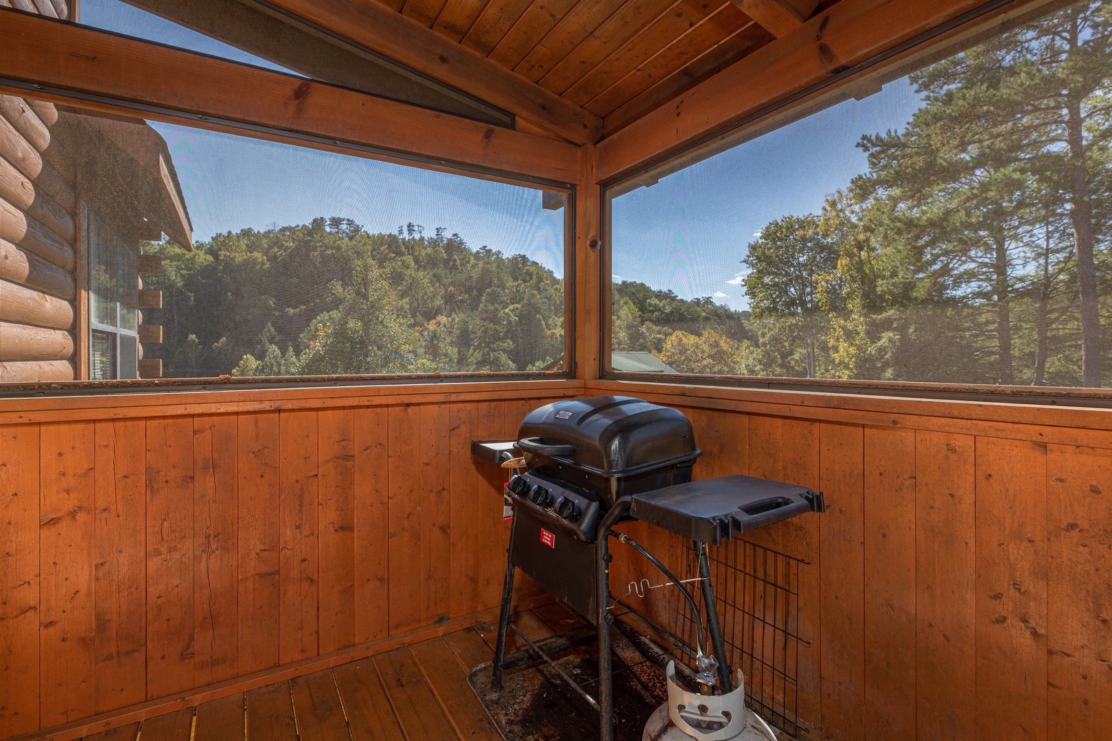 Grill on a screened in porch at Bearadise 4 Us, a 3 bedroom cabin rental located in Pigeon Forge