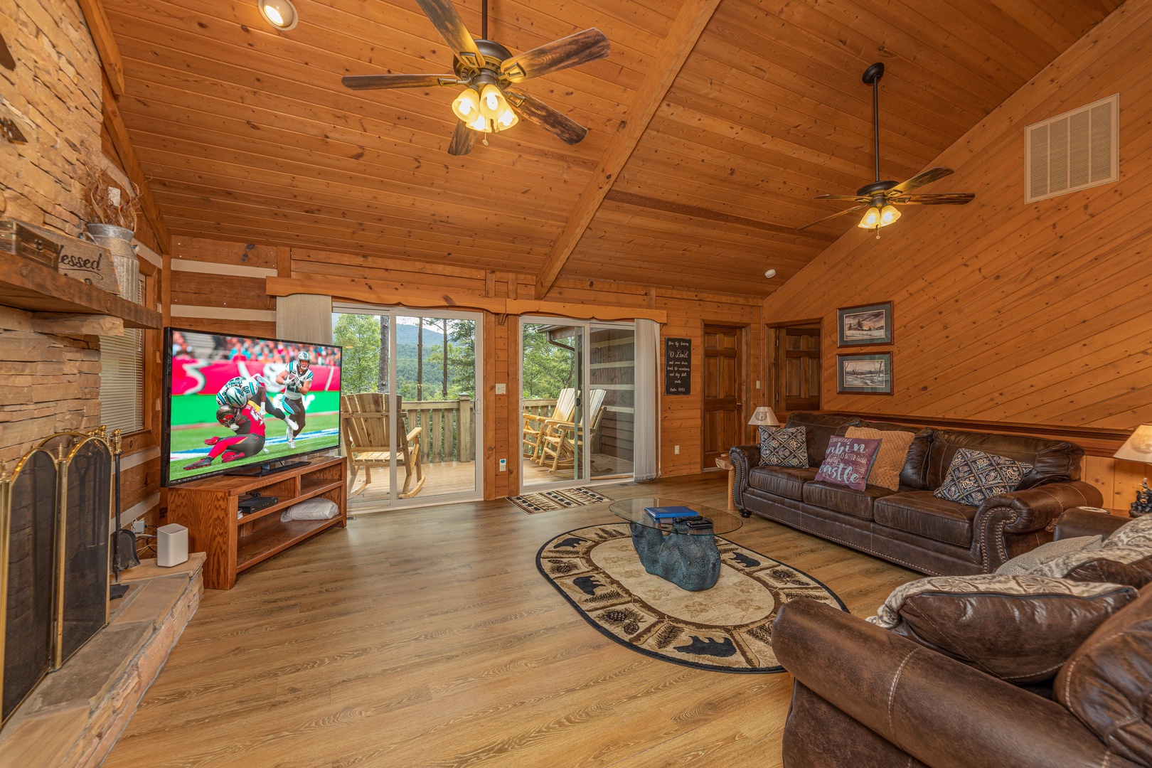 Living room with TV, fireplace, and deck access at Cubs' Crib, a 3 bedroom cabin rental located in Gatlinburg
