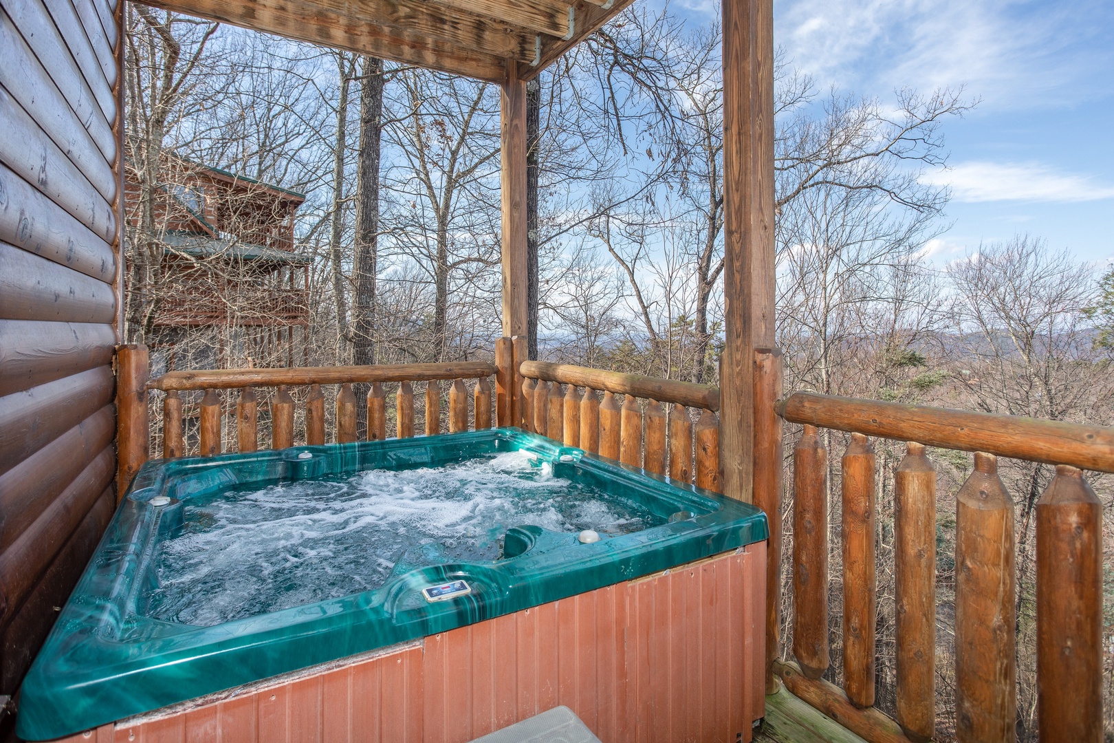 Hot tub on a covered deck at 5 Star View, a 3 bedroom cabin rental located in Gatlinburg