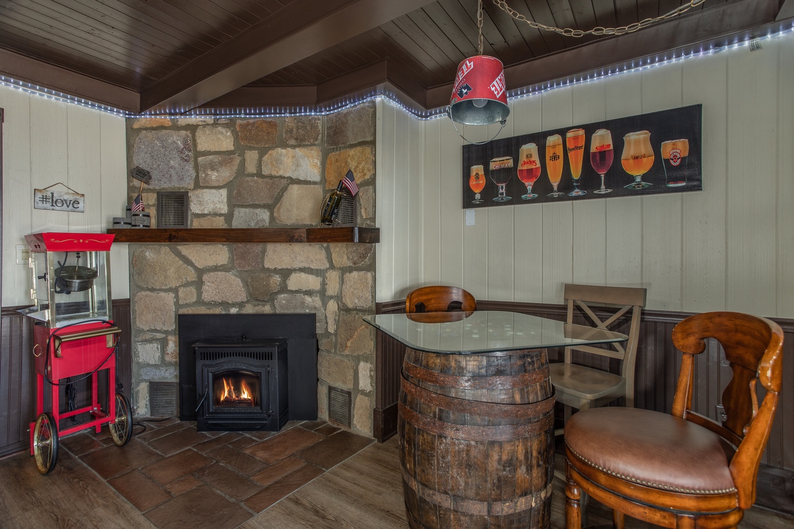 Fireplace, popcorn maker, and pub table on the lower floor at Best View Ever! A 5 bedroom cabin rental in Pigeon Forge