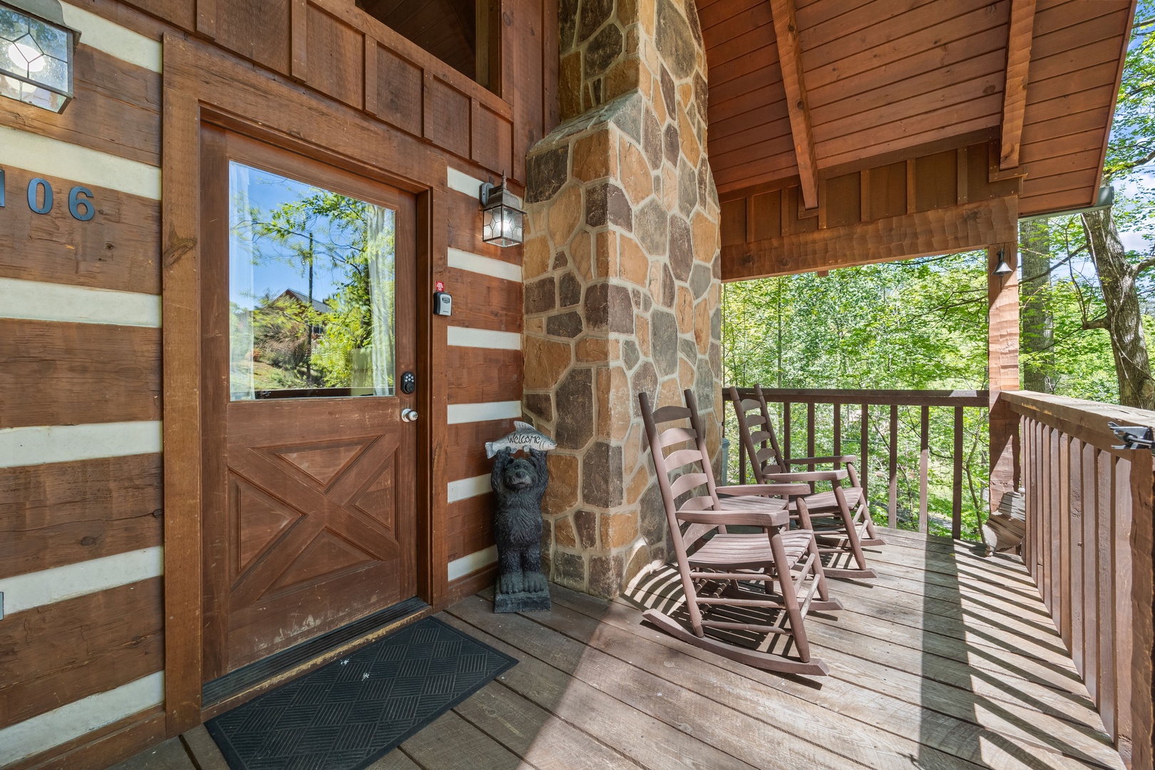 Rocking chairs on the covered deck at Bearfoot Crossing, a 1-bedroom cabin rental located in Pigeon Forge
