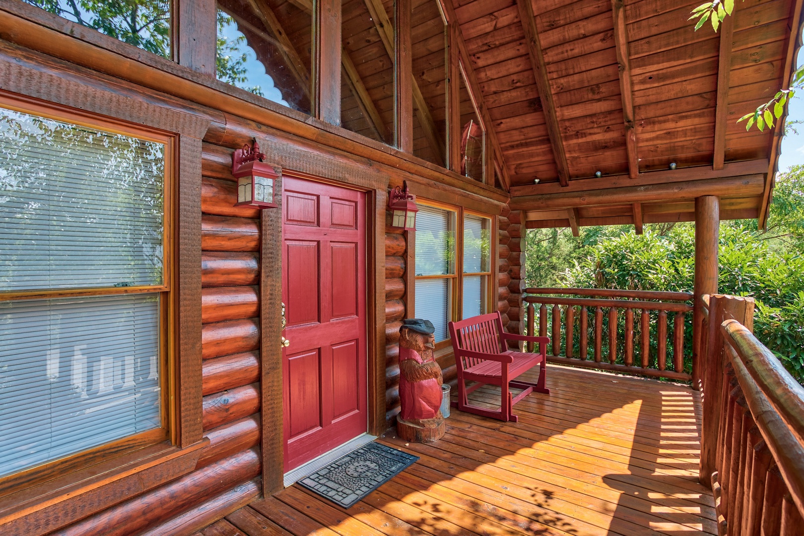 front covered porch with red bench at alpine sunset thrill a 1 bedroom cabin rental located in pigeon forge