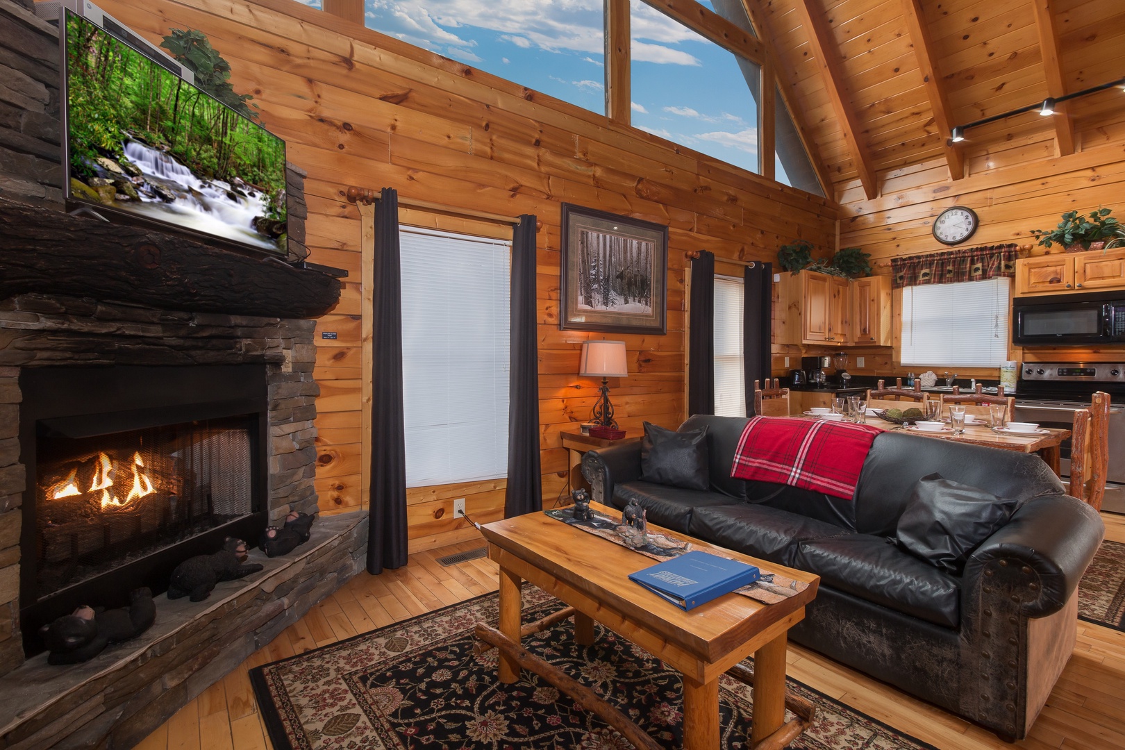 Living room with fireplace and TV at Country Bear's Getaway, a 3-bedroom cabin rental located in Gatlinburg