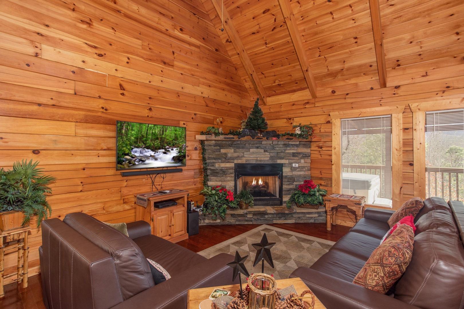 Fireplace, TV, and king sleeper sofa in the living room at Enchanted Evening, a 1 bedroom Pigeon Forge cabin rental