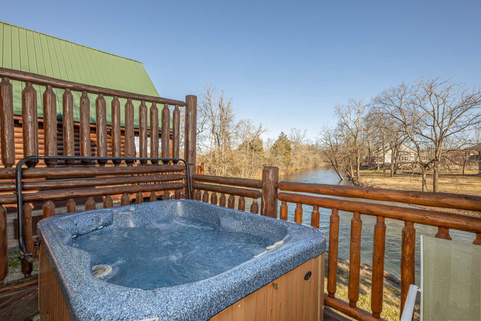 Hot tub overlooking the river at Gone Fishin', a 2-bedroom cabin rental located in Pigeon Forge