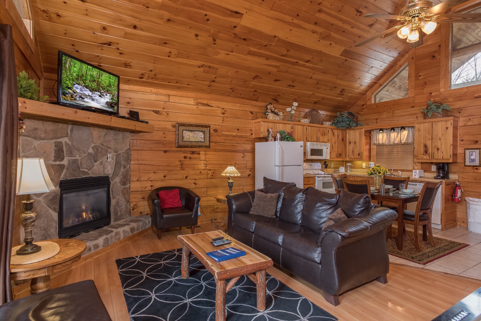 Living room, dining space, and kitchen at Precious View, a 1 bedroom cabin rental located in Gatlinburg